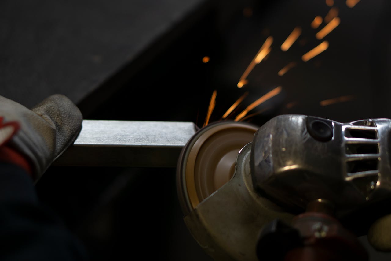 menu-01 Angle grinder working on steel, emitting bright sparks. Industrial close-up shot.